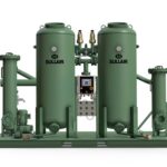 CompressAir | Industrial air compressor system by sullair, featuring two large green tanks, additional smaller components, and a central control panel, all mounted on a green platform.
